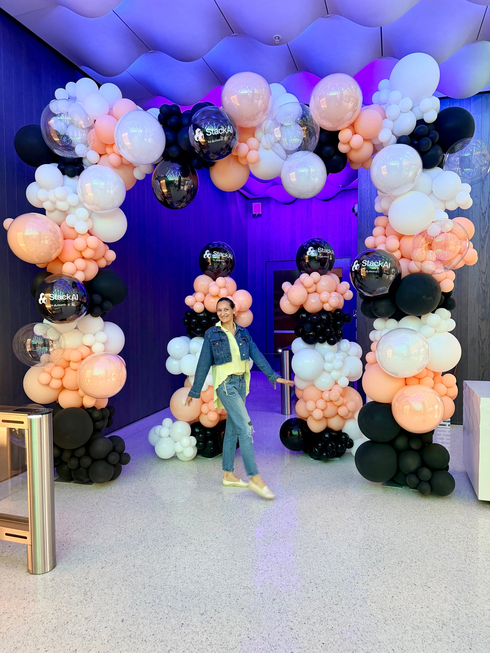 Modern peach white and black corporate balloon installation for an Asana AI event