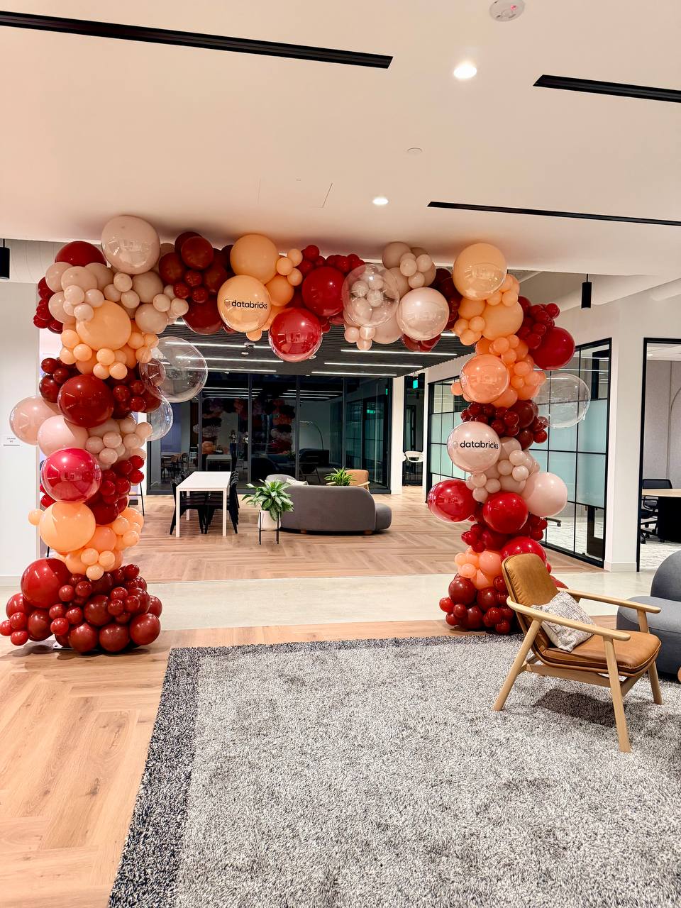 Professional red and orange corporate balloon arch at a Databricks event in Silicon Valley