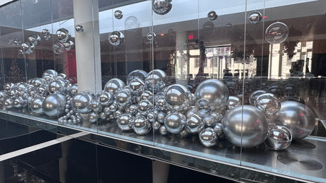 Large silver chrome and clear balloon installation for a cultural center opening in San Francisco