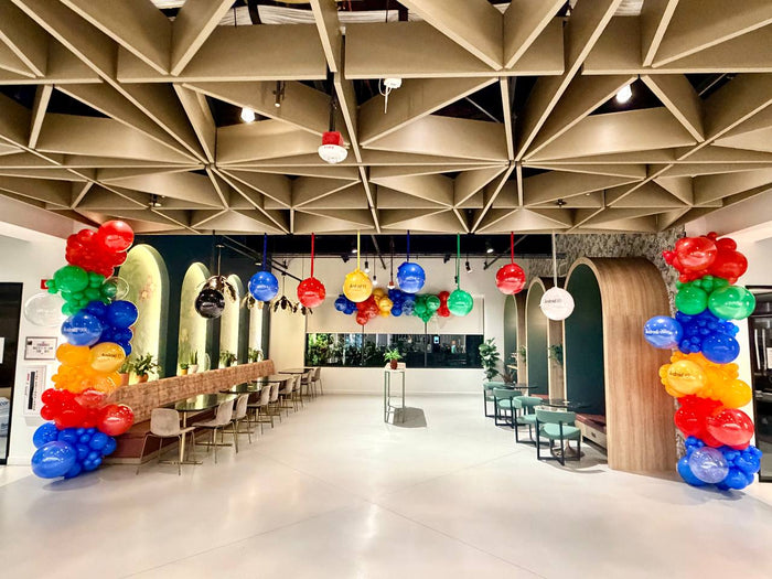 Colorful balloon columns and suspended Android XR balloons at a corporate event
